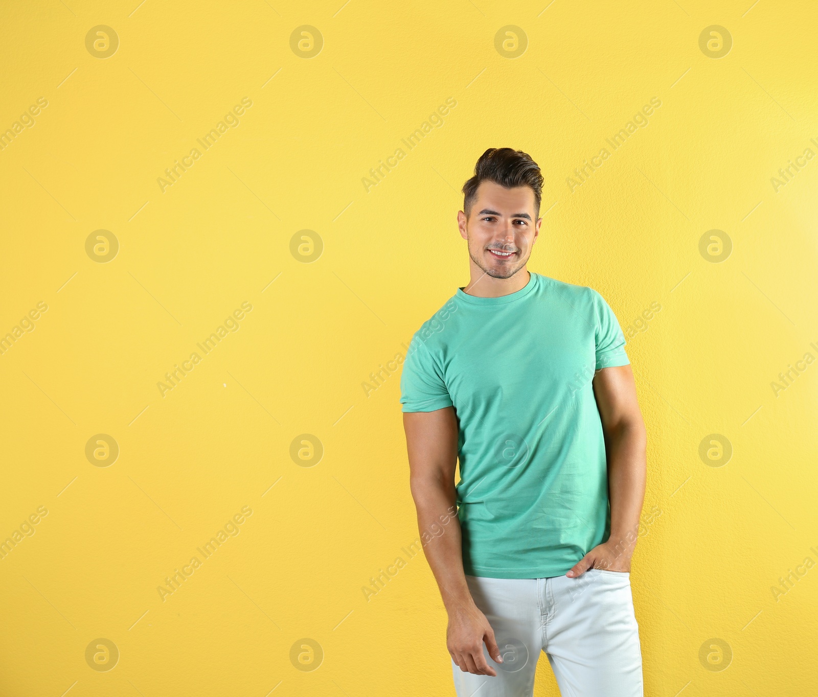 Photo of Young man in t-shirt on color background. Mockup for design