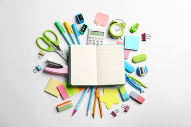 Photo of Blank notebook and school stationery on white background, flat lay with space for text. Back to school