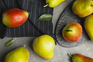 Photo of Ripe juicy pears on grey stone table, flat lay