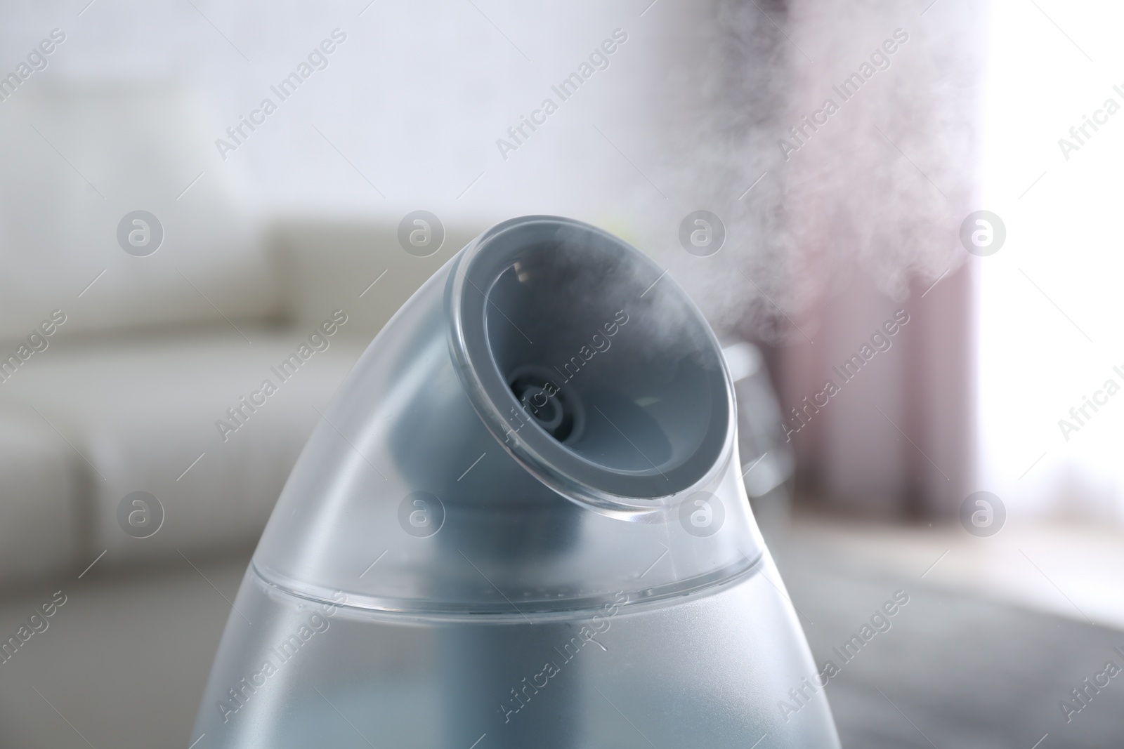 Photo of Modern air humidifier at home, closeup view