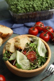 Photo of Salad with fresh organic microgreens in bowl on wooden table