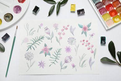 Photo of Flat lay composition with floral picture and watercolor paints on white background