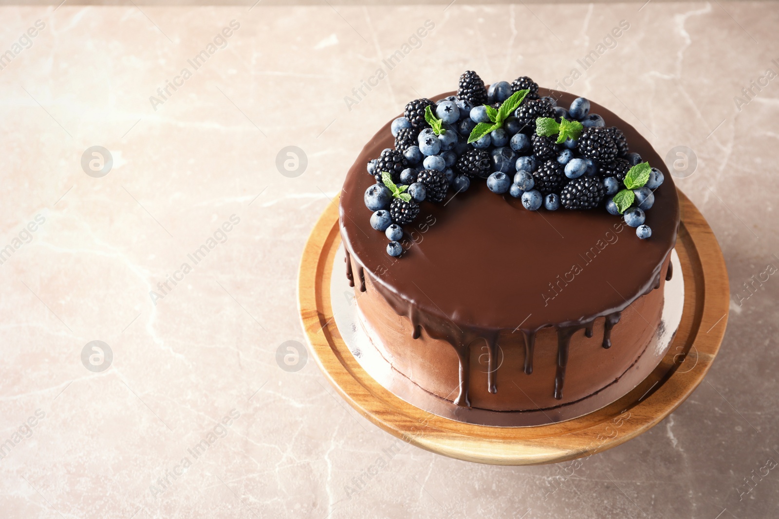 Photo of Fresh delicious homemade chocolate cake with berries on table. Space for text