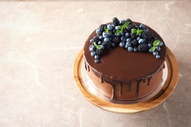 Photo of Fresh delicious homemade chocolate cake with berries on table. Space for text