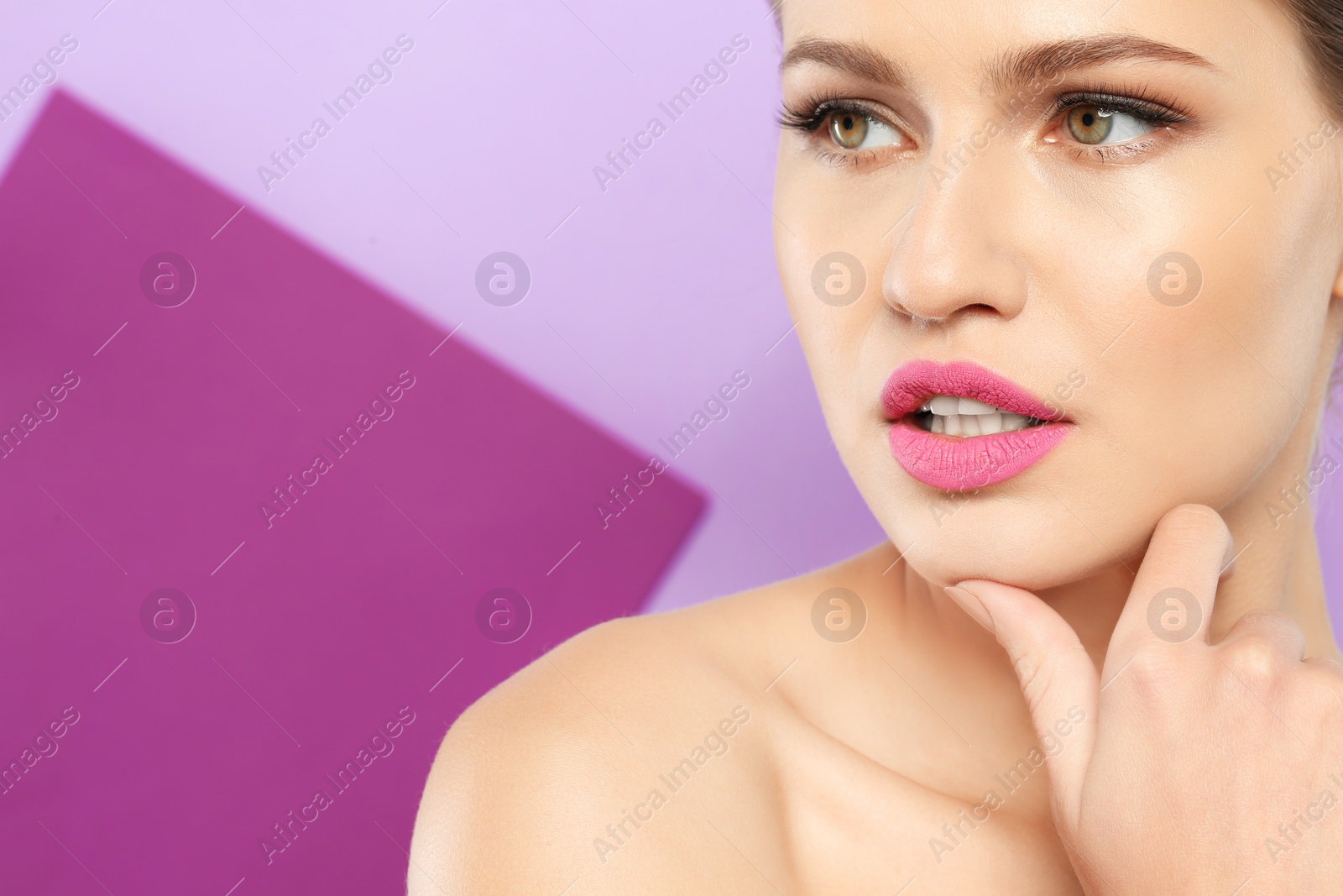 Photo of Young woman wearing beautiful lipstick on color background. Space for text