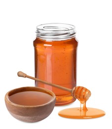 Natural honey dripping from dipper. Jar full of honey and bowl on white background