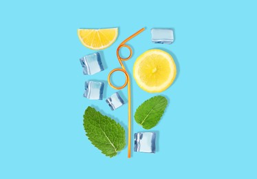Creative lemonade layout with lemon slices, mint, ice cubes and straw on turquoise background, top view