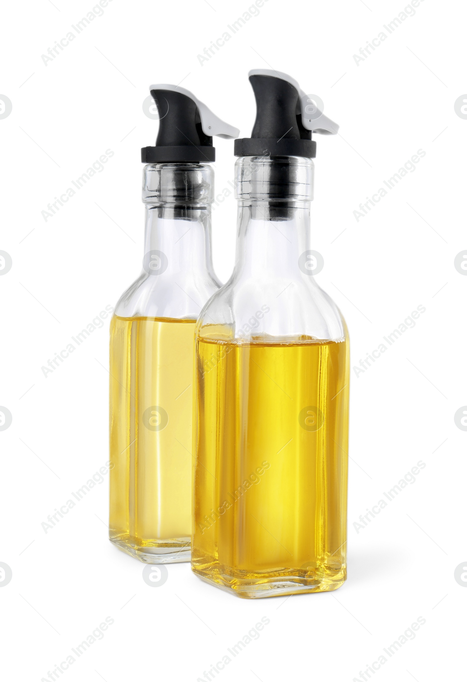 Photo of Glass bottles with cooking oil on white background