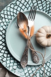 Autumn table setting with pumpkin on blue wooden background, closeup