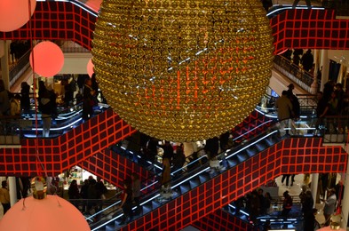 Paris, France - December 10, 2022: Crowded Le Bon Marche mall with beautiful Christmas decor