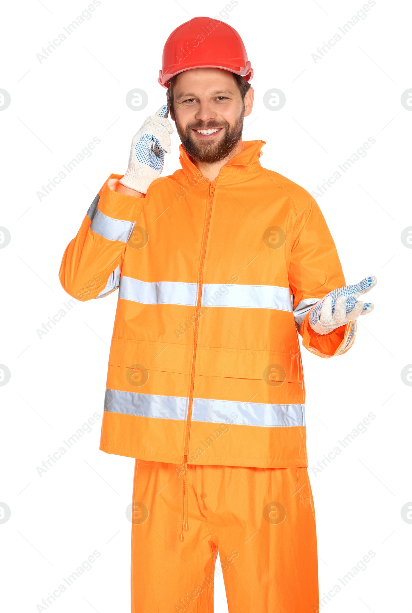 Photo of Man in reflective uniform talking on smartphone against white background