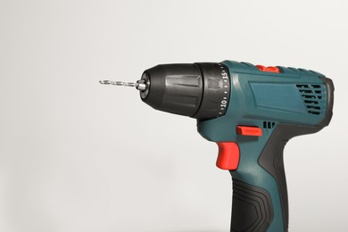 Modern electric power drill on light background