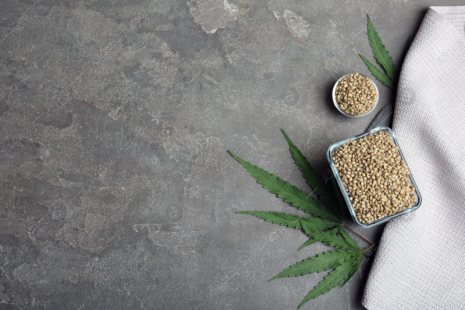 Photo of Flat lay composition with hemp seeds and space for text on grey background