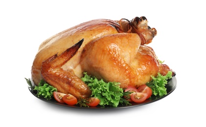 Photo of Platter of cooked turkey with garnish on white background