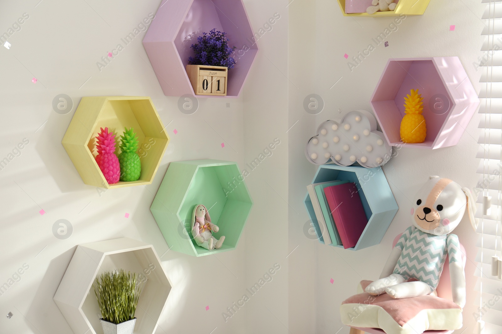 Photo of Hexagon shaped shelves on white wall. Interior design