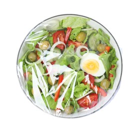 Photo of Plate of fresh salad wrapped with transparent plastic stretch film isolated on white, top view