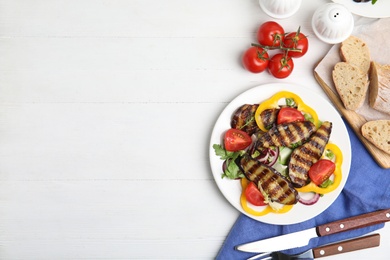 Photo of Delicious salad with roasted eggplant served on white wooden table, flat lay. Space for text