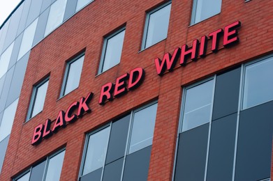 Photo of Warsaw, Poland - September 10, 2022: Building with modern Black Red White logo