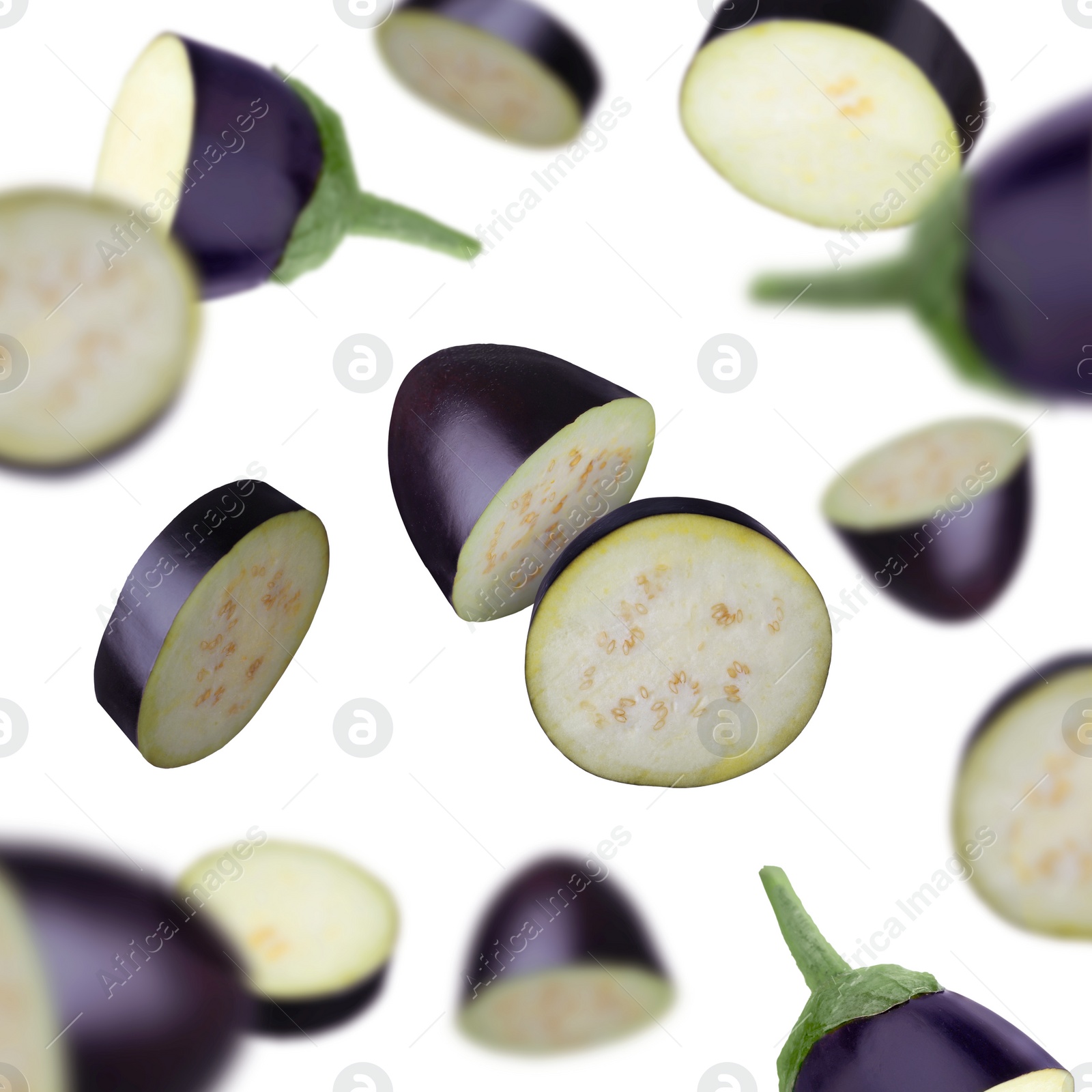 Image of Slices of eggplants falling on white background