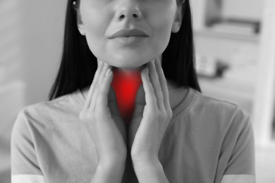 Endocrine system. Woman doing thyroid self examination, closeup. Color accent effect