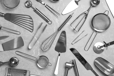 Cooking utensils on grey marble table, flat lay