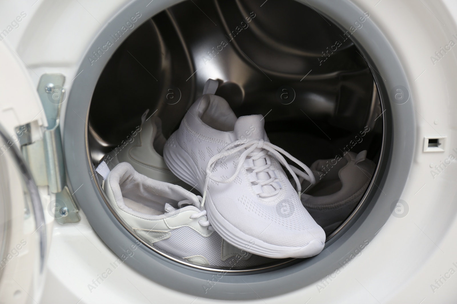 Photo of Clean sports shoes in washing machine drum