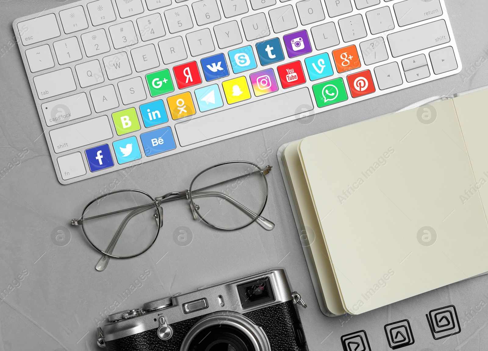 Image of MYKOLAIV, UKRAINE - APRIL 30, 2020: Computer keyboard with social media apps logotypes on grey table, flat lay