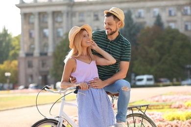 Photo of Happy couple with bicycle outdoors on summer day