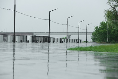 Empty city embankment under heavy rain on spring day