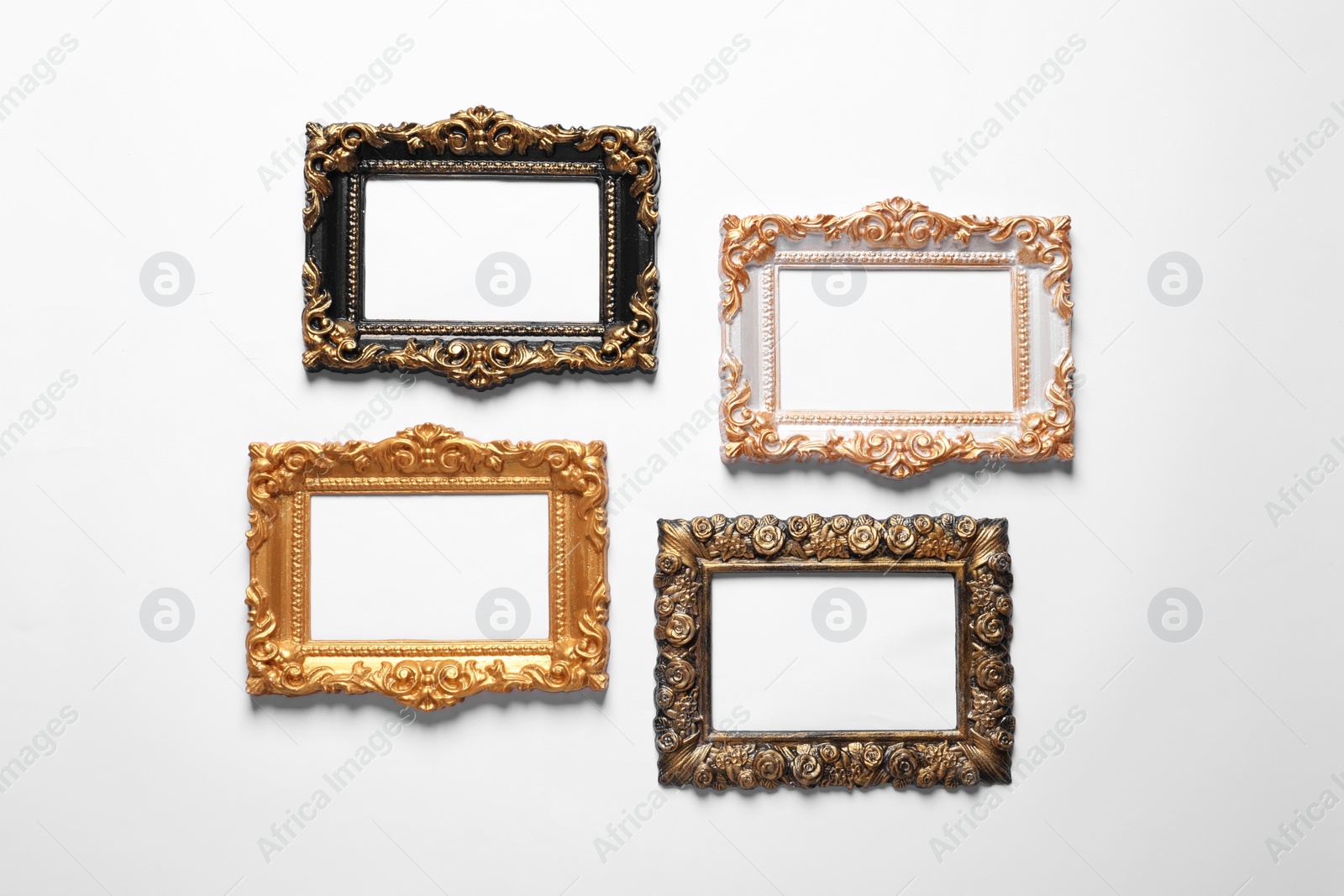 Photo of Blank vintage frames hanging on white wall