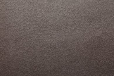 Photo of Texture of dark leather as background, closeup