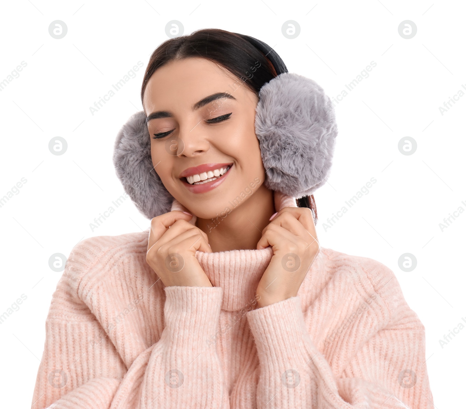 Photo of Beautiful young woman wearing earmuffs on white background