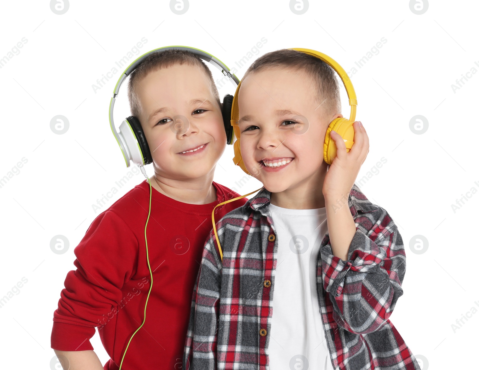 Photo of Portrait of cute twin brothers with headphones on white background