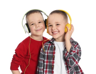 Portrait of cute twin brothers with headphones on white background
