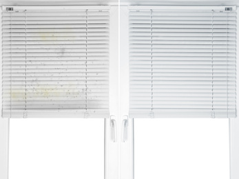 Window with dirty and clean blinds 