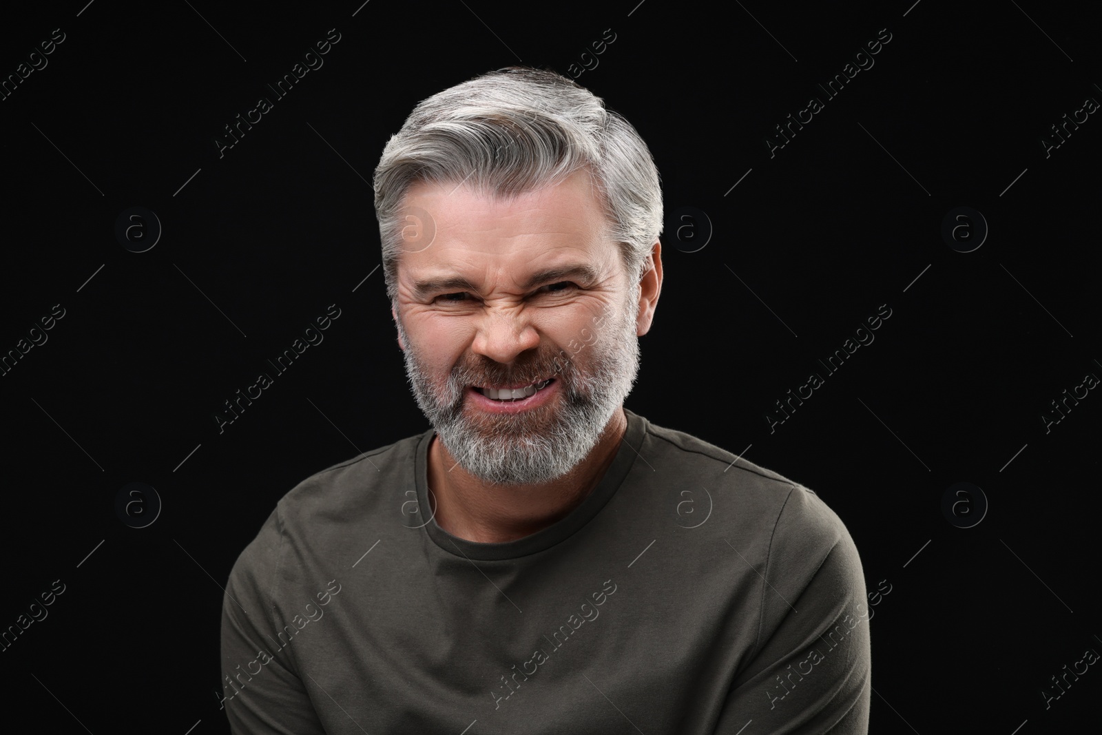 Photo of Personality concept. Portrait of emotional man on black background