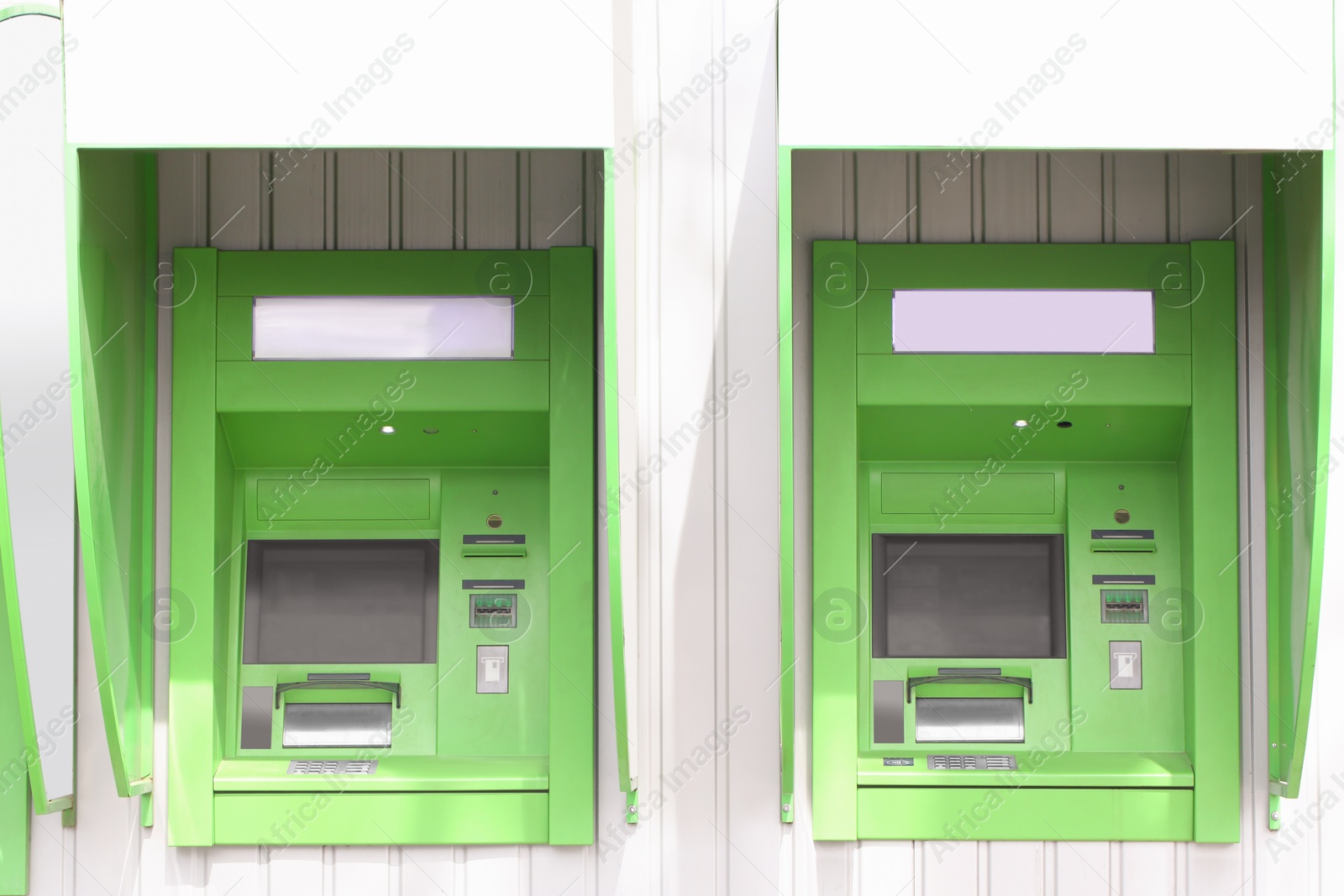 Photo of Modern automated cash machine with screen outdoors