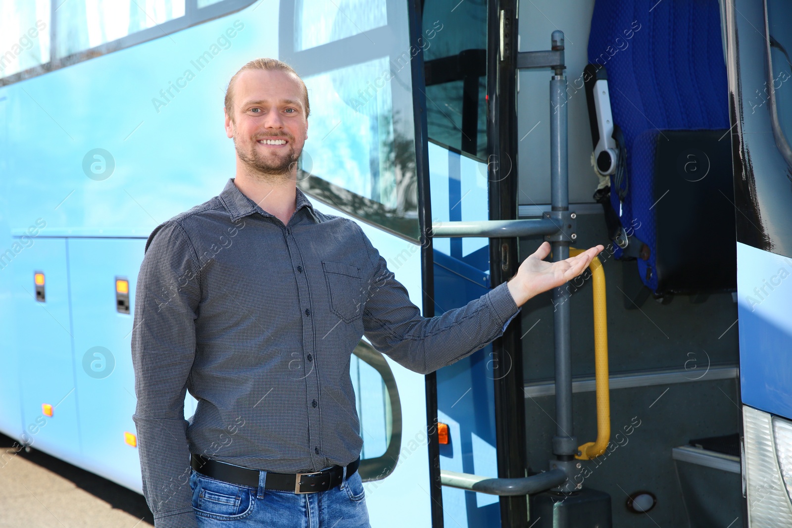 Photo of Professional driver standing near bus. Passenger transportation