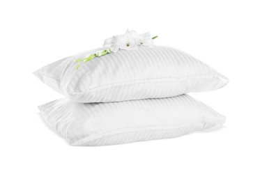 Soft pillows with beautiful flower on white background