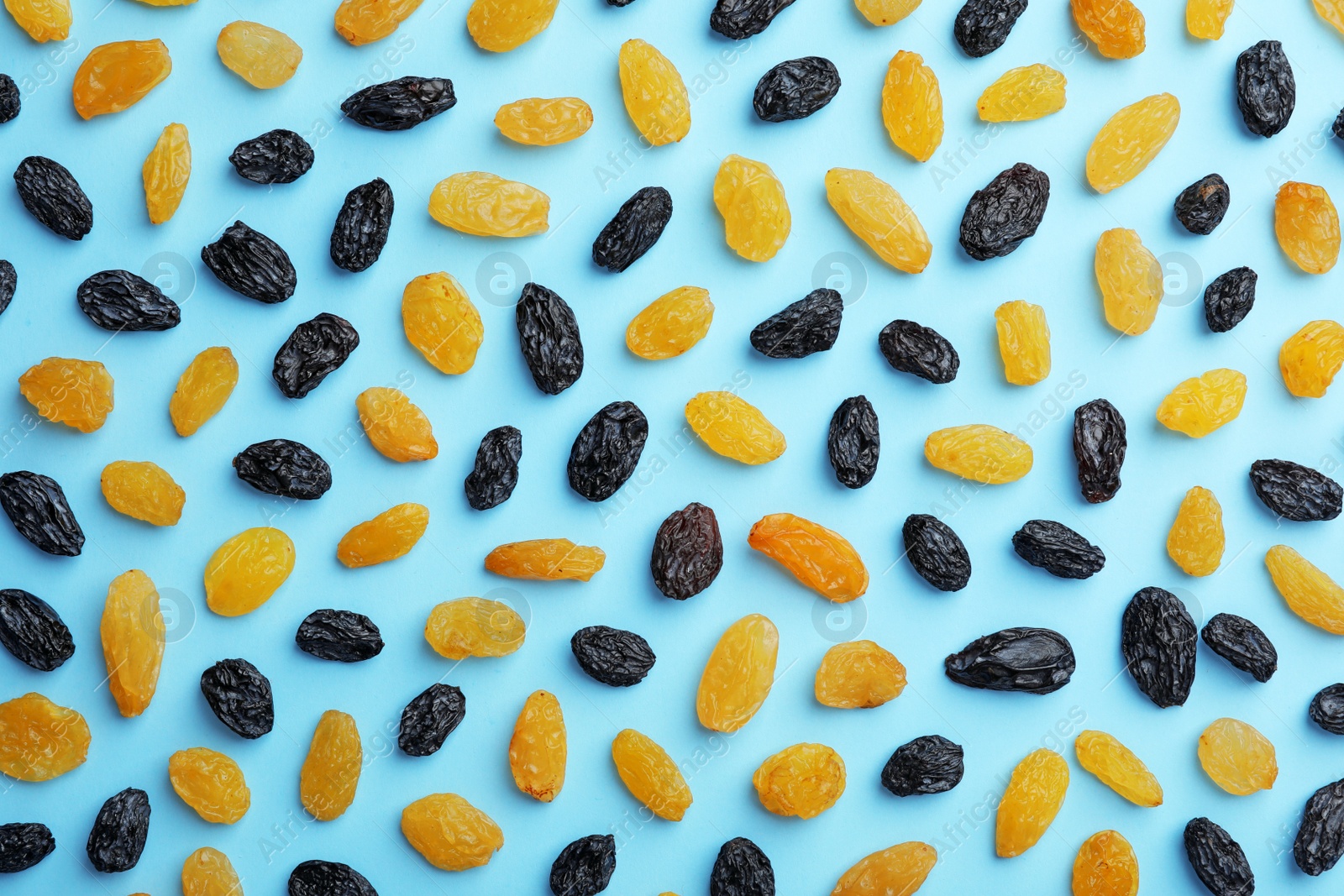 Photo of Flat lay composition with raisins on color background. Dried fruit as healthy snack