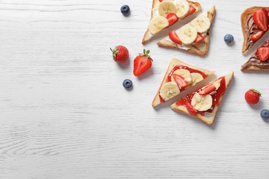 Photo of Tasty toast bread with banana and strawberry on light background