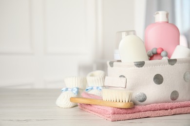 Photo of Baby accessories on white wooden table indoors. Space for text