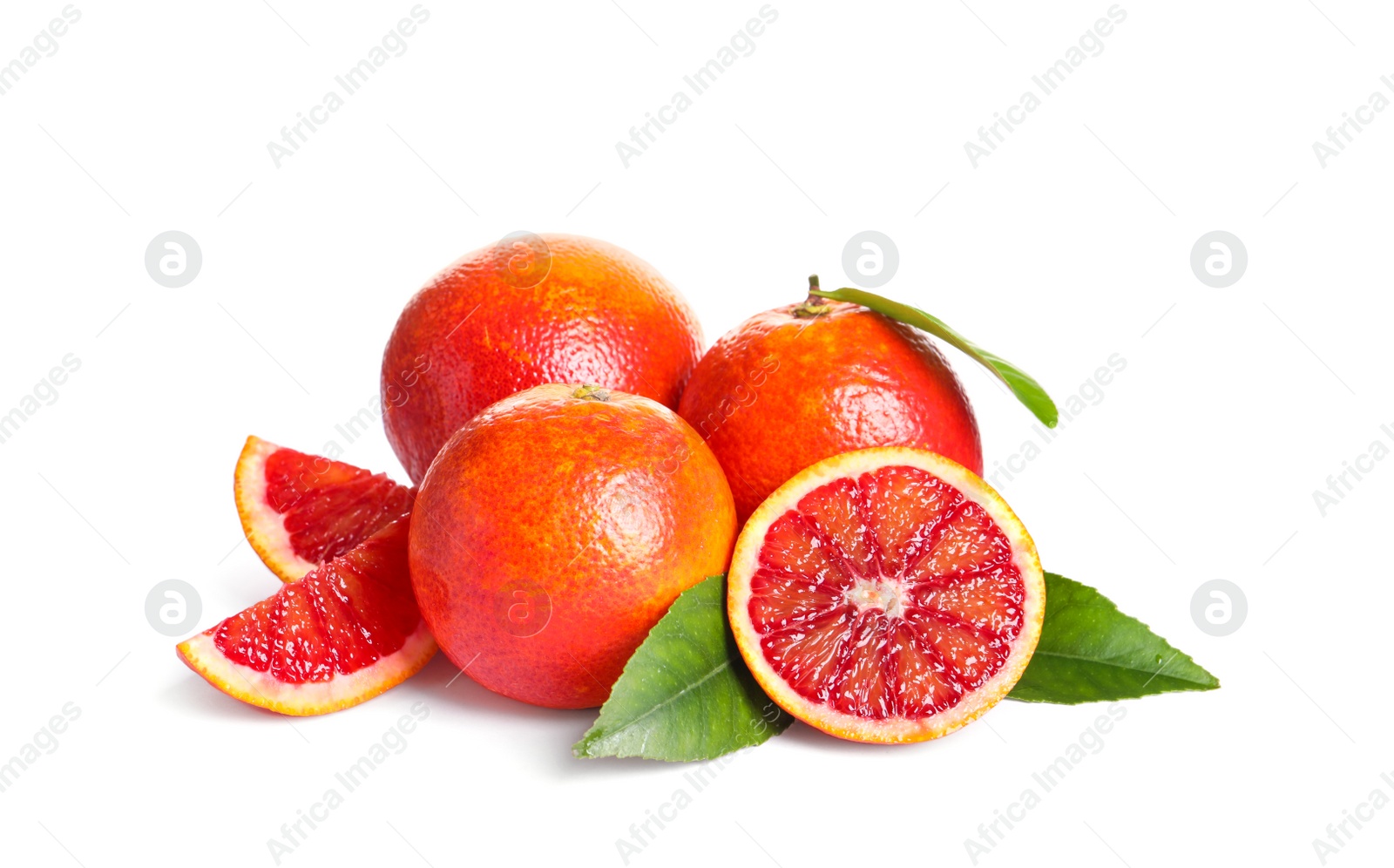 Photo of Whole and cut red oranges with green leaves on white background