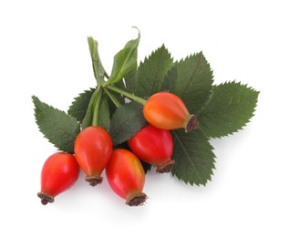 Photo of Ripe rose hip berries with green leaves on white background, top view