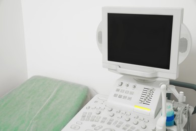 Ultrasound machine and examination table in hospital, closeup