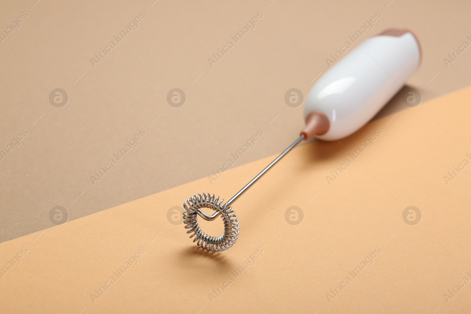 Photo of White milk frother wand on color background, space for text