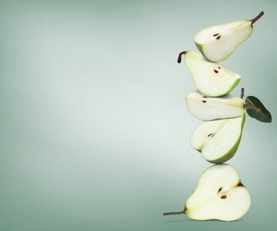 Image of Cut fresh ripe pears on pale green gradient background, space for text