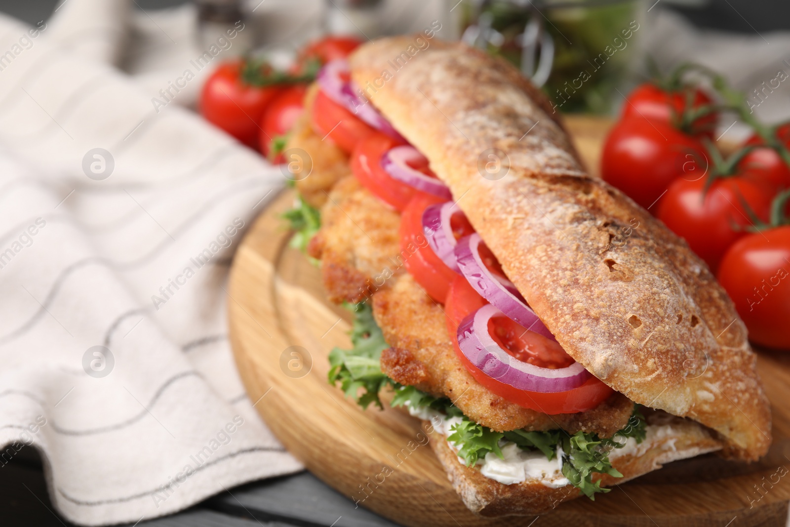 Photo of Delicious sandwich with schnitzel on grey wooden table, closeup. Space for text
