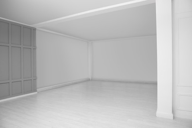 Photo of Empty room with grey wall and laminated floor
