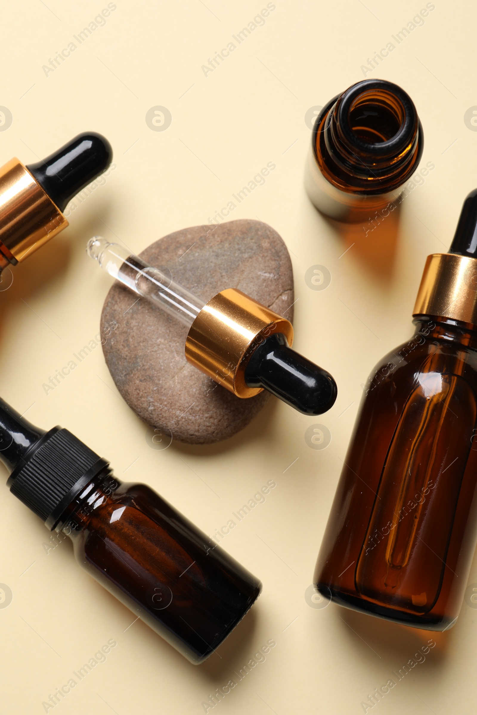 Photo of Flat lay composition with face serums on beige background